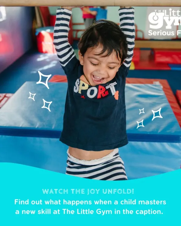 The pure joy of mastering a new skill is what we are all about. Here, a young gymnast beams with pride while hanging on the bar, building upper body strength and confidence in our safe and encouraging environment.