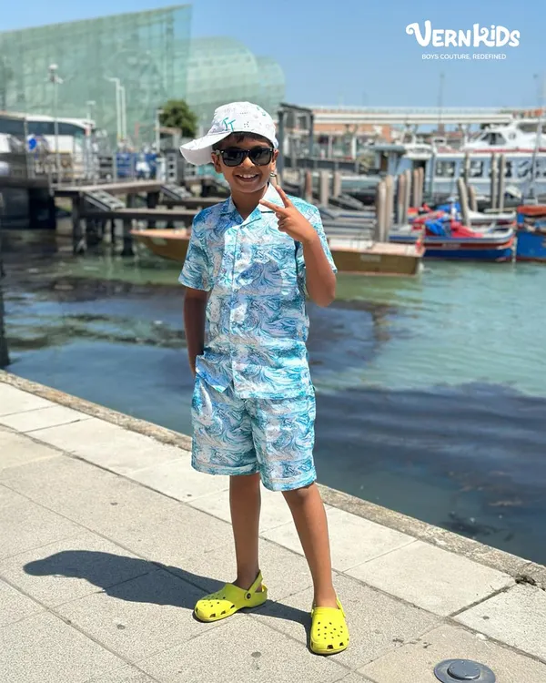 Making waves in our custom summer co-ords. This blue marble-print set, complete with a matching cap, is the perfect outfit for a day by the water.