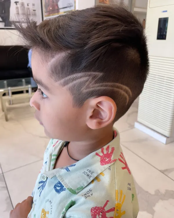Even the little ones get a rockstar look here. I specialize in fun, creative hair art for kids, like this sharp lightning bolt design, making their haircut experience exciting and stylish.