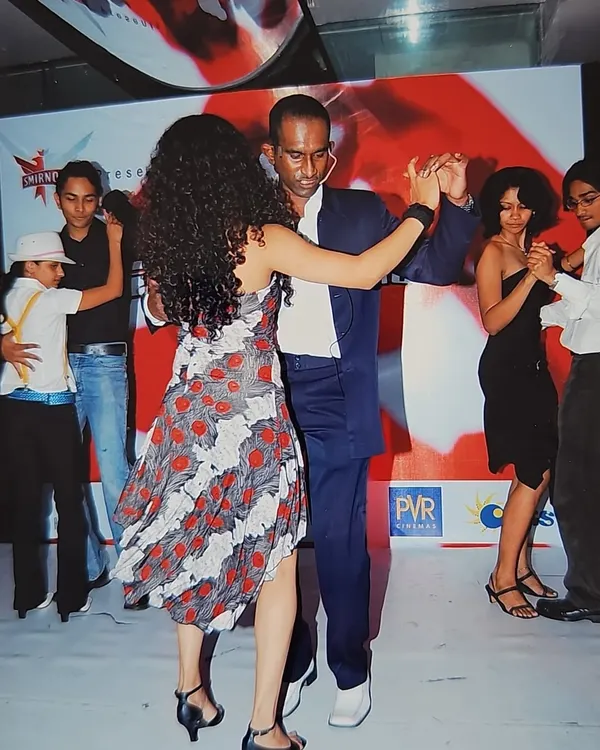 A cherished memory from Salsathon, our intra-studio salsa competition. This photo captures our founder dancing, surrounded by the energy of over 800 students and dance lovers.