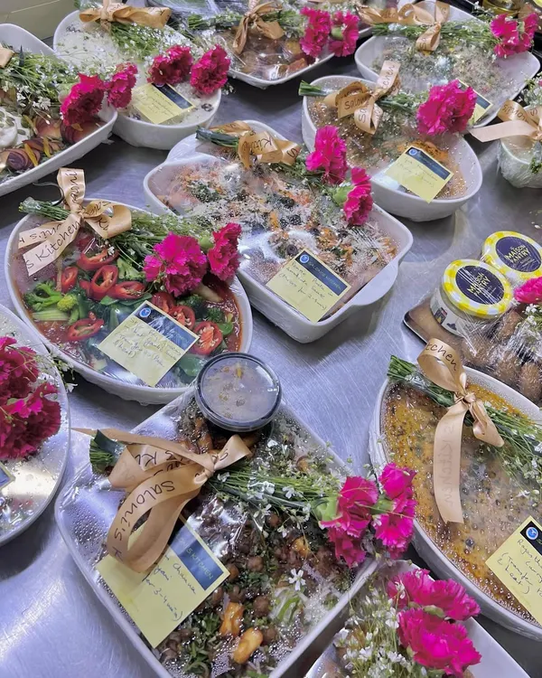 A glimpse into how I deliver joy. Each dish is prepared and plated in beautiful crockery, wrapped with care, and adorned with fresh flowers, turning a simple meal delivery into a truly special gift for any occasion.