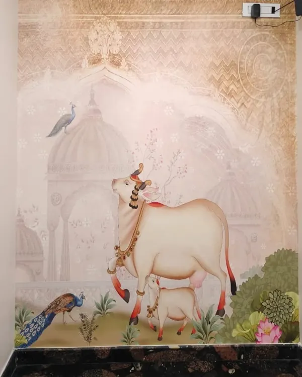 A beautiful Pichwai-style mural featuring a sacred cow and calf against a backdrop of traditional Indian architecture, bringing a sense of peace to this space.