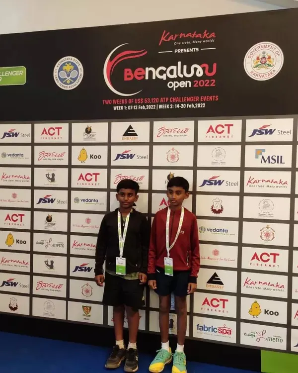 Our top junior players, Sanjay and Ishaan, in front of the official sponsor wall at the Bengaluru Open 2022. We provide our students with exclusive access to professional tournament environments.