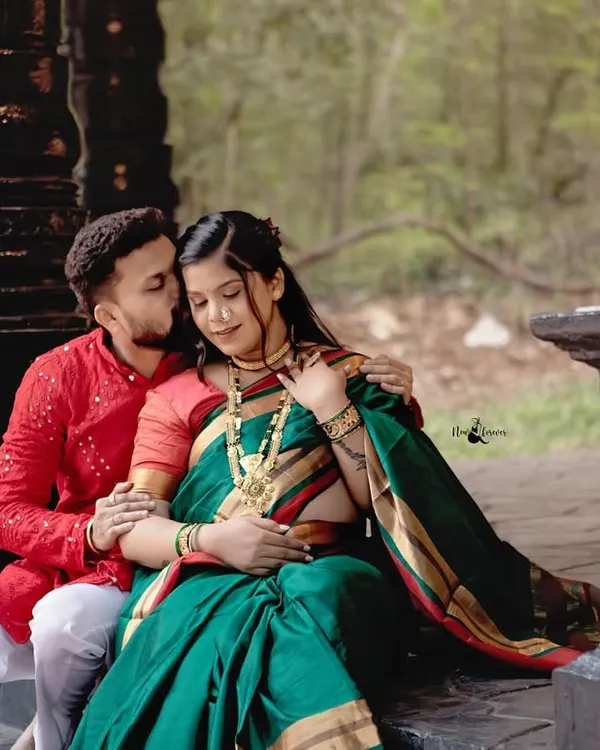 A tender moment captured during a traditional maternity photoshoot. The husband’s gentle kiss and the beautiful green Nauvari saree create a portrait that is rich in both emotion and cultural beauty.