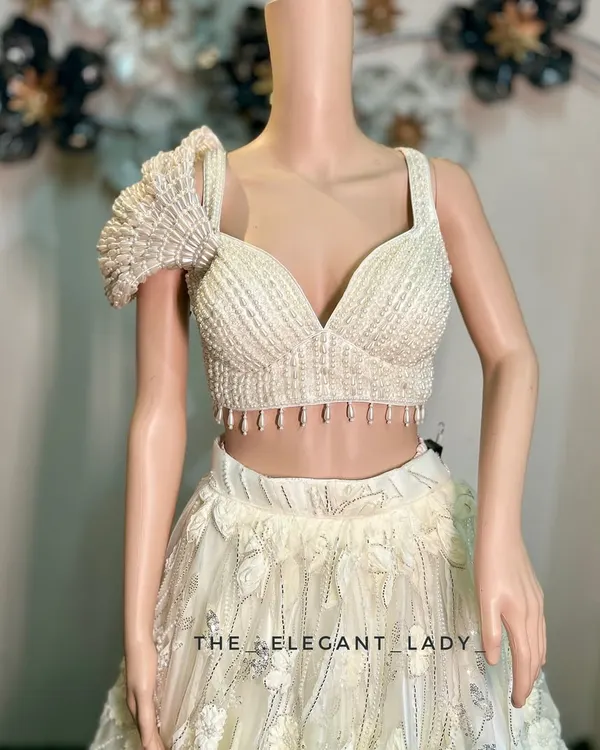 A close-up of the exquisite pearl and beadwork on the blouse of my ivory floral lehenga. The unique ruffled sleeve adds a touch of modern drama to this otherwise ethereal outfit.