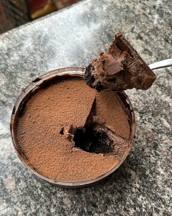 A customer photo of my Dream Cake. It has six different layers and textures of chocolate, from mousse to ganache to cake, all in one tub. It's a chocolate lover's dream.