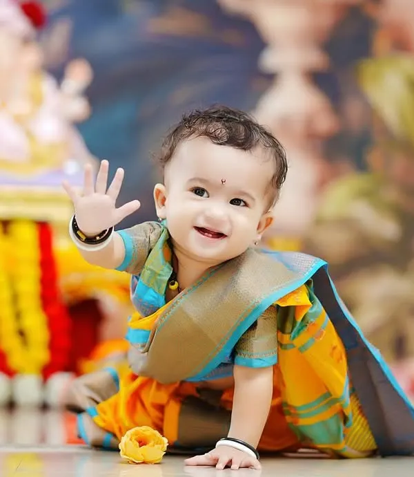 We believe in celebrating milestones with cultural richness. Here, a little one dressed in a traditional dhoti smiles joyfully in our Ganpati-themed setup, complete with a beautiful Ganesha idol and festive decorations. This is one of our most requested cultural baby photoshoots.