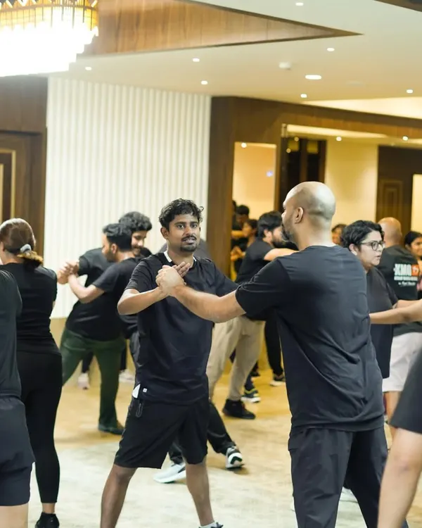 A glimpse into our hands-on training method. Here, one of our certified instructors demonstrates a fundamental wrist release technique, a practical skill for employees to learn for real-world situations. Our focus is always on simple, effective movements that are easy to recall under pressure.