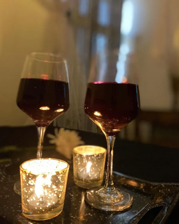 Two glasses of red wine and candles. This is the simple, classic romance that I set up for my guests.