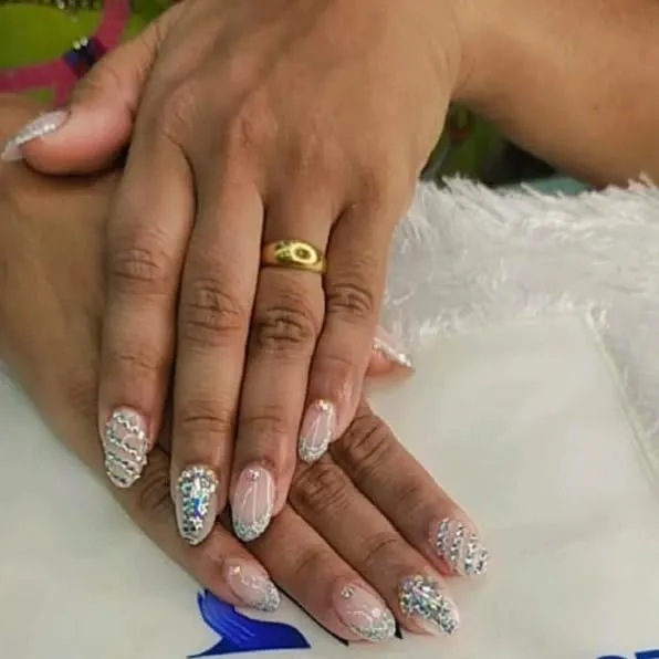 This is the ultimate bridal statement. I meticulously place each crystal and rhinestone to create a dazzling, fully encrusted look on elegant almond-shaped nails, ensuring your hands are ready for every close-up photo on your big day.