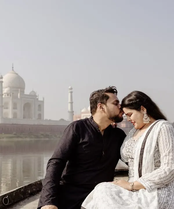 A serene and romantic portrait on a boat, with the Taj Mahal creating a breathtaking backdrop. This angle offers a unique and peaceful perspective, away from the crowds.
