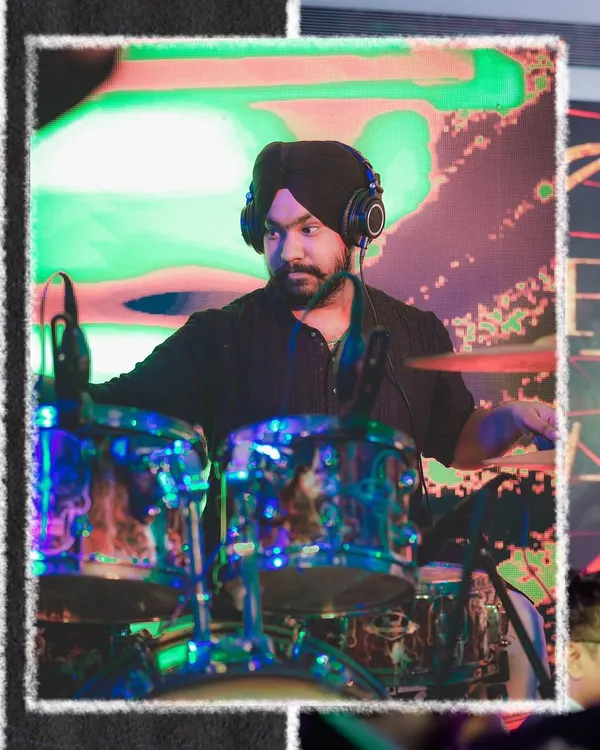 Our drummer, lost in the rhythm. He provides the powerful heartbeat that drives our high-energy performances.