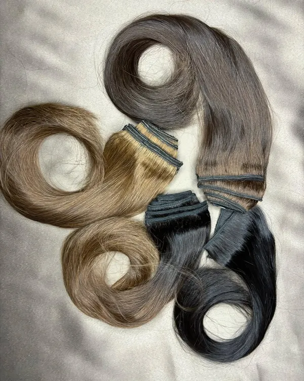 I pride myself on finding the perfect color match for my clients. This image showcases a variety of premium clip-on sets in different natural shades, ready for customization.