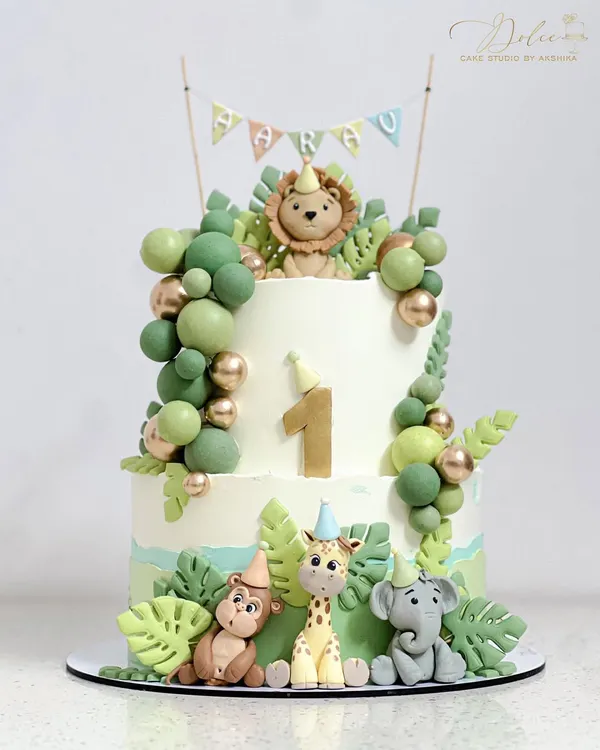 A non-fondant jungle safari cake. All the cute animals, like the lion, giraffe, and elephant, are hand-modelled with fondant, which you'll learn to do in my character class.