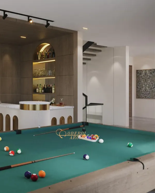 A sophisticated game room featuring a pool table and a stylish custom bar with an arched design and brass accents.