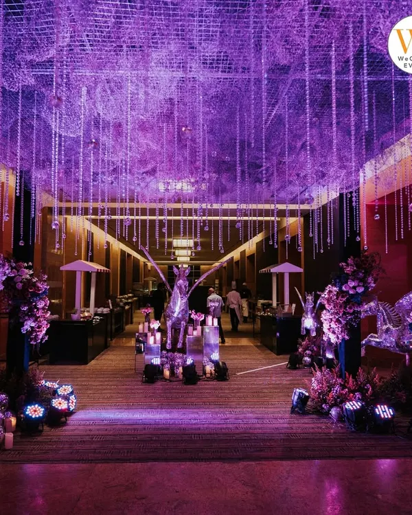 The entrance to the celestial-themed Sangeet set the tone for the entire evening. A dramatic walkway lined with candles, floral arrangements, and shimmering pegasus statues led guests into a magical space.