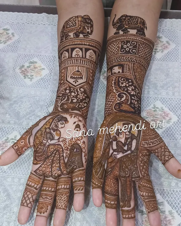 This Teej festival design tells a complete story on both hands, with a couple portrait on one palm and a bride figure on the other. The forearms are decorated with elephant motifs and jhumka patterns.