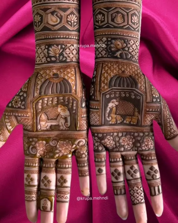 A majestic bridal design featuring royal elephants inside a palace-style jharokha. This is a classic example of full coverage dulhan mehndi for a truly grand wedding look.