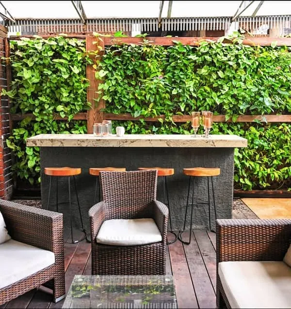 For this residential villa, we designed a semi-open bar and lounge area that seamlessly integrates with nature. We installed a wood-framed living wall with over 700 plants, creating a lush, green backdrop that maximizes vertical space and provides a stunning focal point for entertaining.