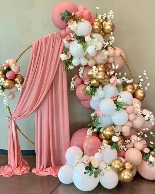 This elegant ring backdrop is perfect for a sophisticated baby shower. I used a mix of pink, white, and chrome gold balloons with delicate flowers and a soft pink drape to create a very classy look.