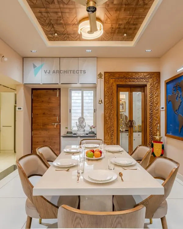 For a travel-loving couple, we designed this dining area to be the heart of their home. The custom world map art piece serves as a constant inspiration for future journeys, while the blend of traditional carved wood and modern furniture creates a space that is both worldly and deeply personal.