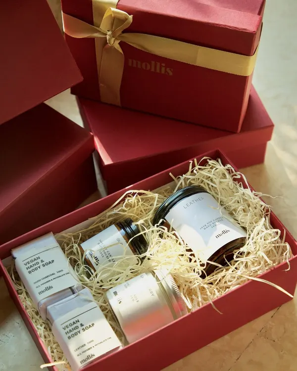 This is my large Diwali gift box, a perfect blend of elegance and indulgence. This burgundy box with a golden ribbon contains a luxurious 200g candle, two 100g candles, and two handcrafted soaps.