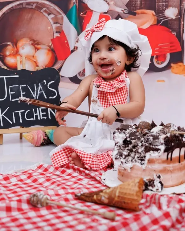 A messy cake smash is the best cake smash! This little chef had a blast digging into her first birthday cake.