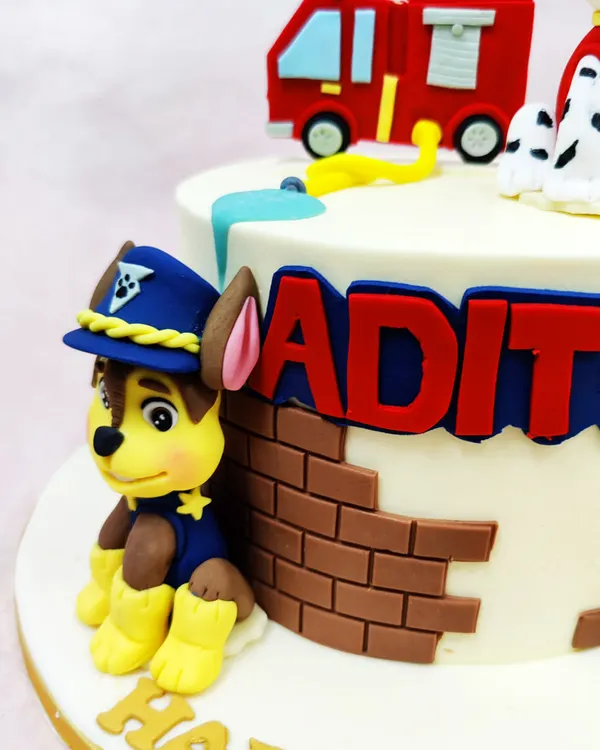 A close-up of our Paw Patrol cake, showing the expertly crafted fondant figure of Chase in his police uniform, ready for action.