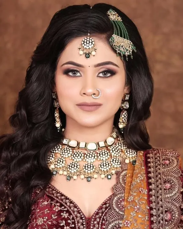 A heavy Kundan choker with a unique design and a matching passa, perfect for a bride seeking a statement look.