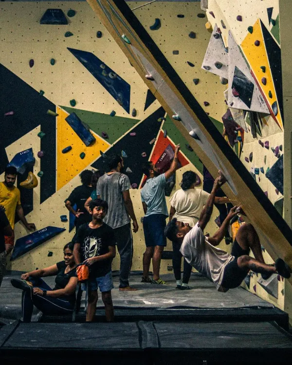 Welcome to Mud and Mettle. This is what our open sessions look like: a space full of energy, with people of all levels challenging themselves, learning new climbing techniques, and supporting each other on our diverse bouldering walls.