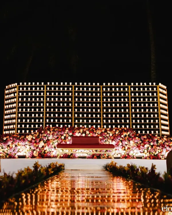 A full view of the spectacular candle wall I designed for a reception stage. The grid of hundreds of glowing candles created an incredibly romantic and dramatic backdrop for the entire evening.