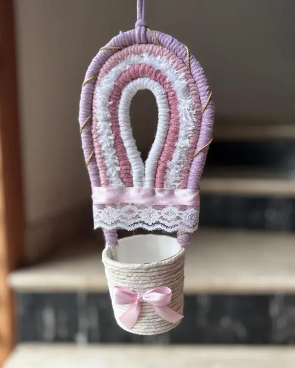 Drift into dreamland with this soft pastel macrame hot air balloon. It adds a touch of uniqueness and whimsy to your child's nursery, and can be customized in your favorite colors.