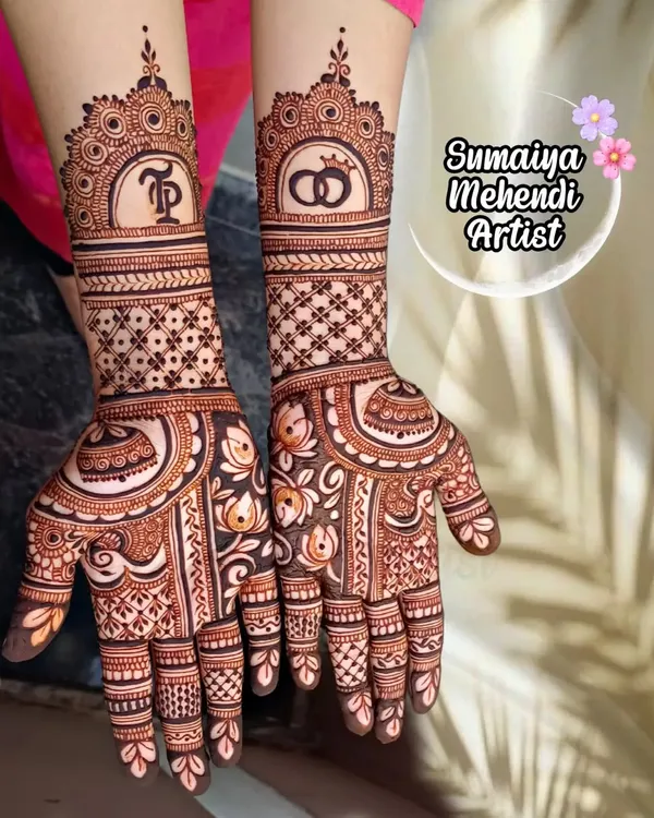 A perfect design for an engagement. This semi bridal henna features the couple's initials 'TP' and wedding rings, symbolizing their commitment.