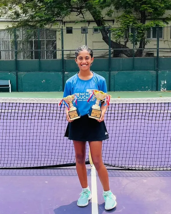 A champion's smile. Our student Eshal Pathan proudly displays her singles finalist and doubles winner trophies from the All India U16 Championship Series.