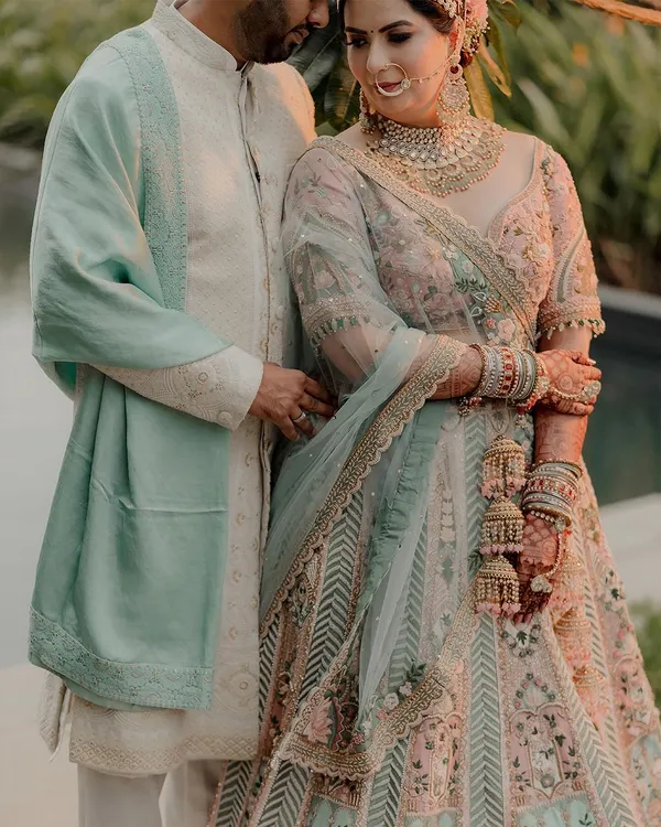 A beautiful portrait of a couple in pastel outfits, capturing a moment of quiet connection in a garden setting.