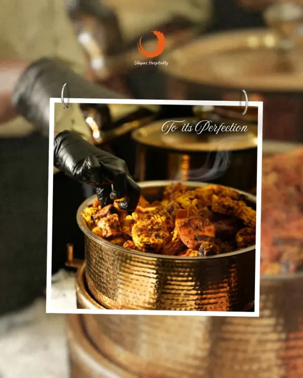 Every dish is crafted with care and perfected with passion. Our chef is seen here adding the final touches to a rich, steaming curry in a traditional copper pot, showcasing our commitment to culinary excellence.