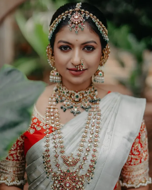 This is the look that captures my heart: a classic South Indian bride, radiant in a traditional Kanchipuram saree and exquisite temple jewellery. My focus is on creating a flawless, glowing complexion and defining the eyes to honour our heritage with timeless elegance.