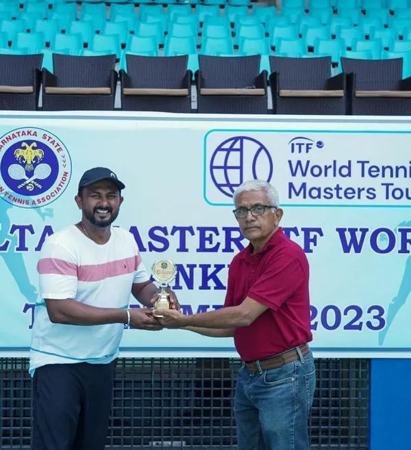 Our founder, Amogha Shivaram, receiving a trophy at the ITF World Tennis Masters Tour. His ongoing success as a player directly informs our practical and athlete-centric approach to event management.