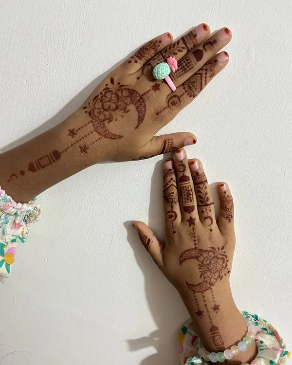 A cute and festive Eid design for a child, featuring crescent moons, stars, and hanging lanterns.