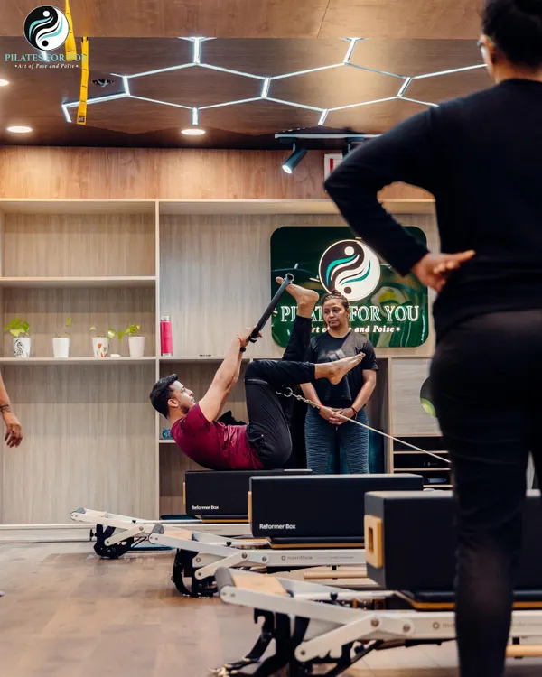 Under my expert supervision, this client is performing an advanced exercise that requires significant core strength and control. This is the level of precision and power we work towards in my sessions.