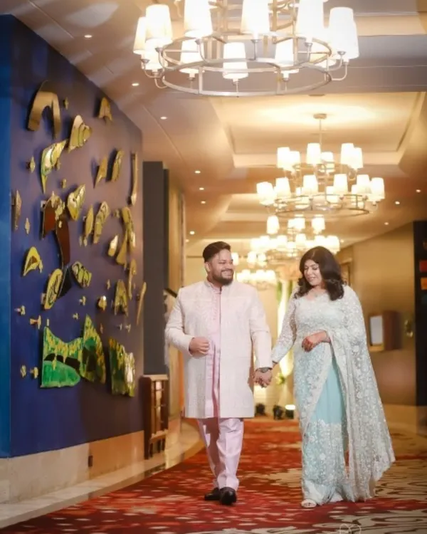 A classic couple portrait taken during their reception. The grand hotel corridor and elegant lighting provide a beautiful backdrop, and I focus on capturing the couple's relaxed and happy demeanor as they walk hand in hand.