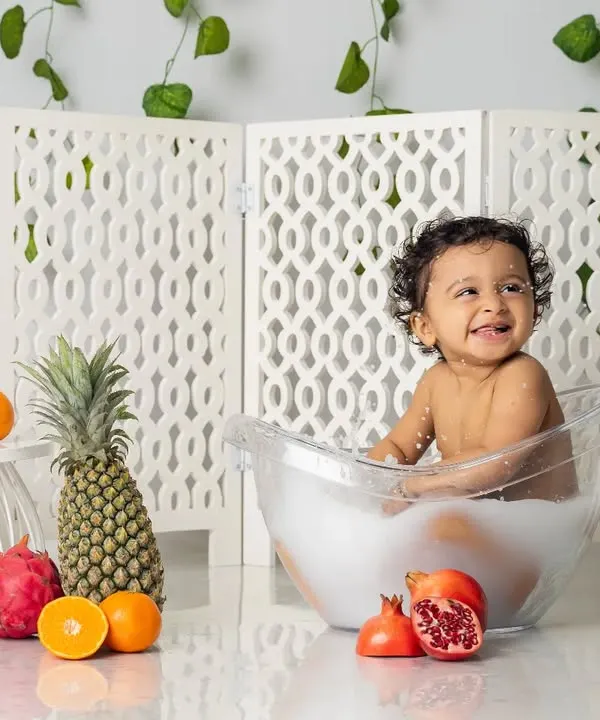 A bubbly, happy splash in the tub. Our milk bath sessions are designed to be pure fun, and this little one's smile says it all.