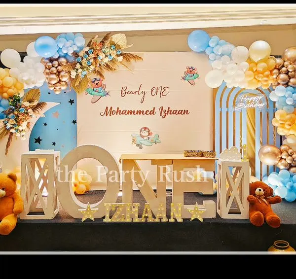 Mohammed Izhaan's "Bearly ONE" birthday was a dream with this teddy bear and airplane theme. The setup features a soft blue and cream color palette, fluffy balloon clouds, and adorable teddy bears ready for an adventure.