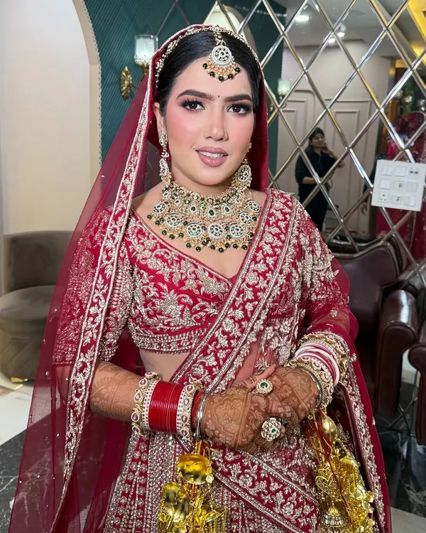 A stunning full-length view of my bride in her magnificent red and gold lehenga. The makeup is kept classic and radiant to let the intricate outfit and her beautiful smile shine.
