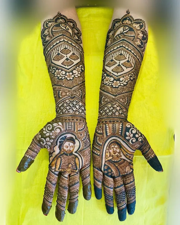 This full bridal design features detailed portraits of the bride and groom on each palm, surrounded by intricate traditional patterns. Capturing the couple's likeness is my specialty and the heart of my custom bridal work.