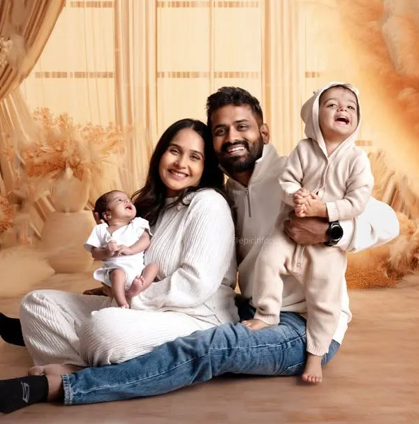 A beautiful family portrait celebrating new beginnings. We love capturing these joyful, complete family moments, including proud parents and excited older siblings, all in one perfect frame.