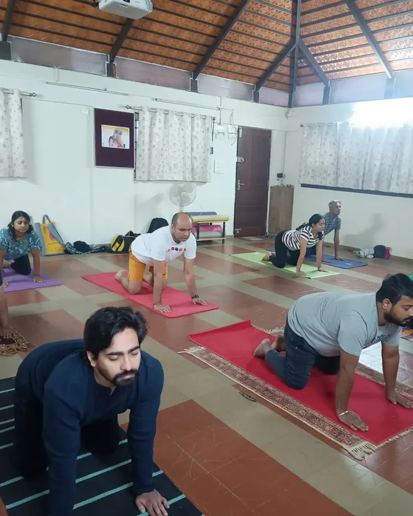 A typical morning class in our Bangalore studio. Participants are seen here in a preparatory posture for Surya Kriya. My focus is always on providing individual corrections and ensuring everyone is aligned correctly to get the most out of their practice.