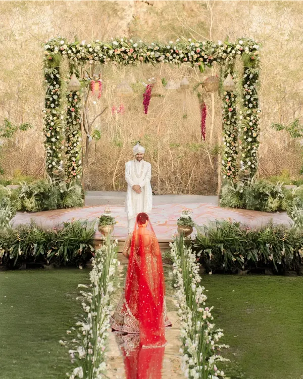 This is a moment of poetry. The bride's entry, as she walks a path lined with flowers towards the man waiting for her, is a story in itself.