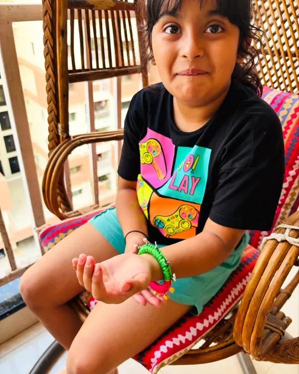 The pure joy on a child's face when she sees her new bangle! This piece is designed to be colorful, fun, and safe for kids to wear.