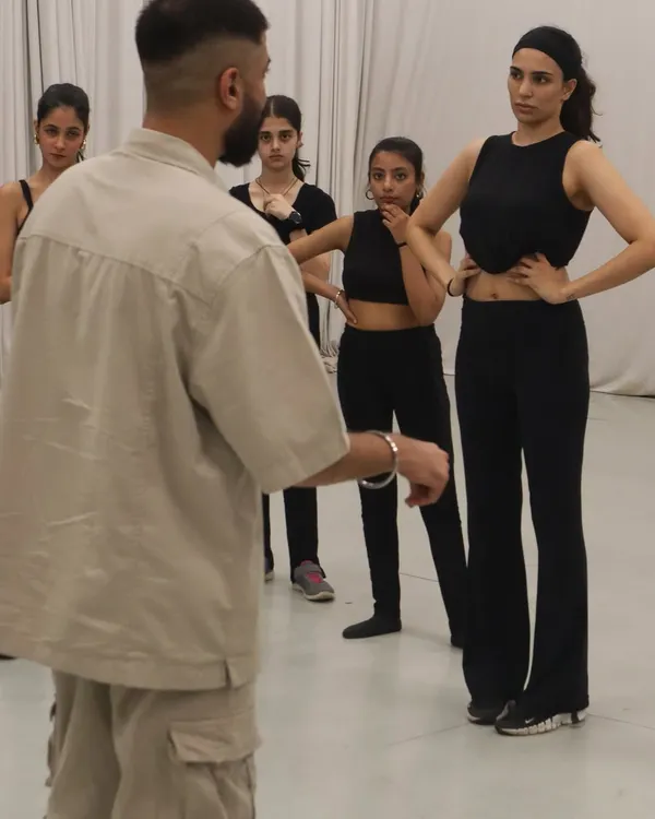 A close-up of a teaching moment where students are focused and engaged. I ensure everyone understands the details of the choreography before we move on.